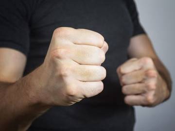 extort man with raised fists photo