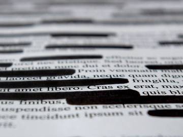 lorem-ipsum-dummy-text-with-black-marks-on-it-indicating-a-textual-redaction